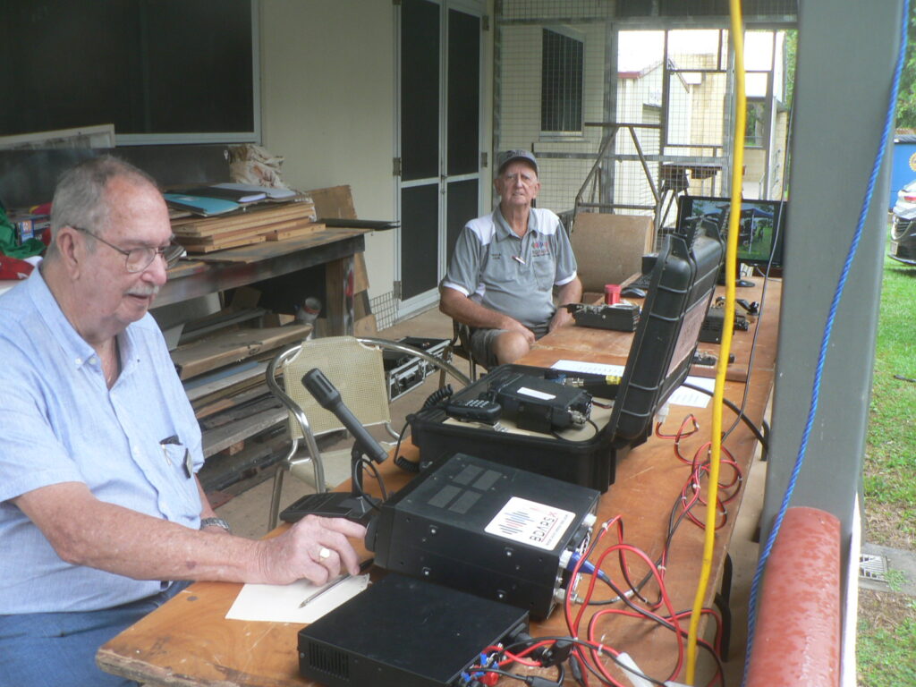 Eddie and Tom on verand. Tom operating portable HF rig.